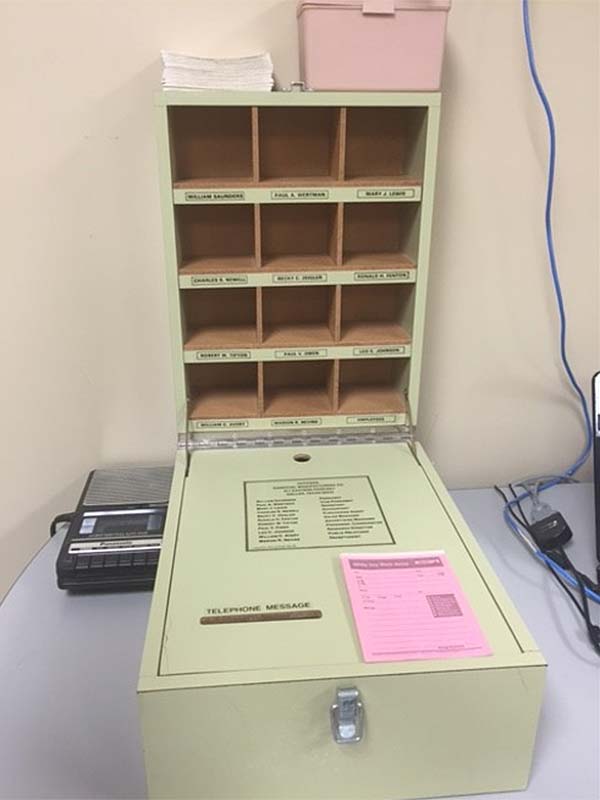 Tool used in the vocational assessment program to evaluate an individual's simulated assembly skills. The grey painted tool consists of a turntable and two drawers containing a number of black/white pegs that can be inserted into the turntable.