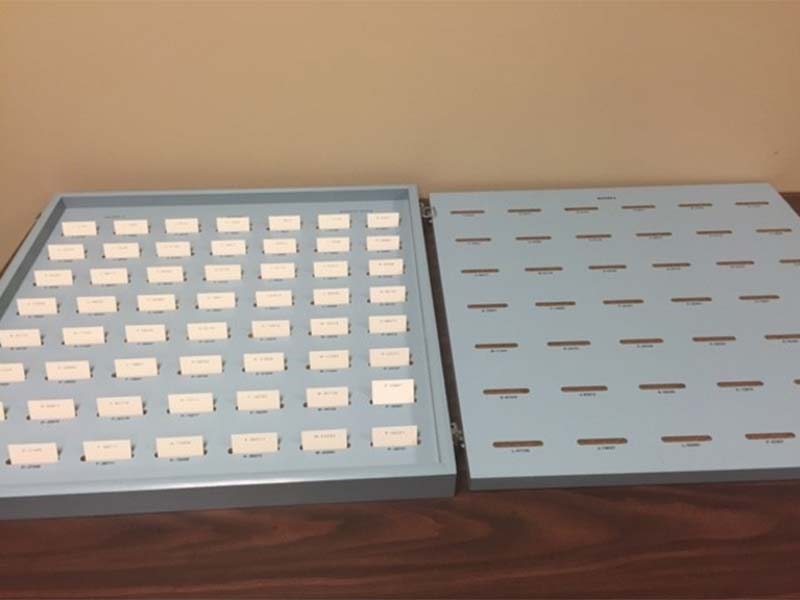 Tool used in the vocational assessment program to evaluate an individual's numerical sorting ability. This grey painted desktop tool consists of a number of moveable or sortable numbered tags.